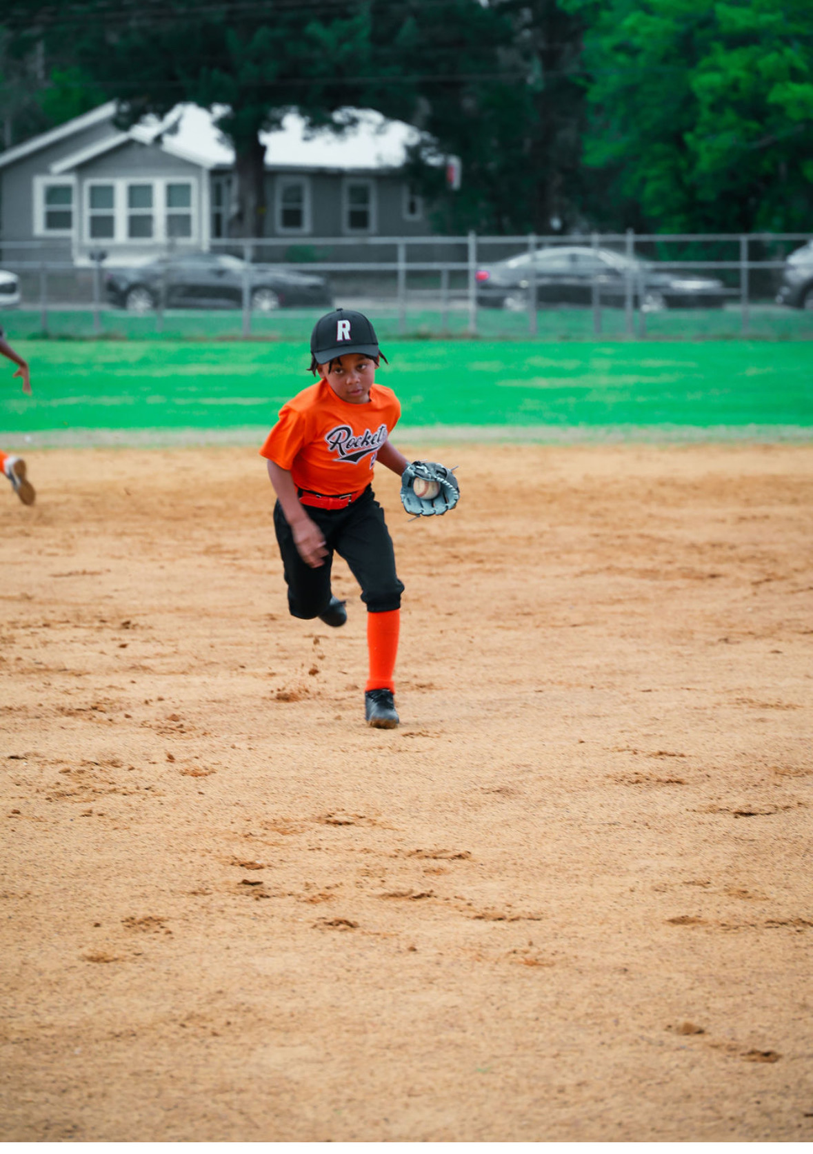 Young Rockets player running in the field